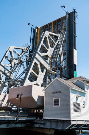 MYSTIC, CT - AUGUST 14, 2014: The iconic drawbridge in Mystic open for a small boat on August 14, 2014 in Mystic, Connecticut USA.のeditorial素材