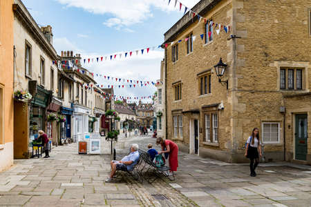 CORSHAM, UK - JULY 17: a person rides his bike in a street in Corsham, an old village in south of England on July, 17, 2015 in Corsham, UKのeditorial素材