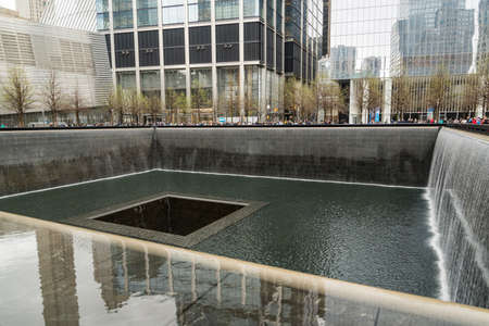 NEW YORK CITY - APRIL 20, 2019: Names of victims inscribed on the bronze walls surrounding the south tower footprint at the 9 11 Memorialのeditorial素材