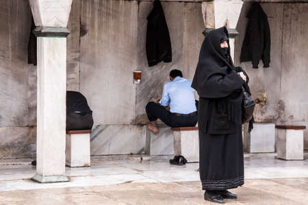 ISTANBUL, TURKEY - FEBRUARY 9, 2013. Muslim people wash their feet before entering in mosque in...