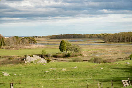 Spring farm and hay field with blue sky and clouds in Maine, USA.の写真素材