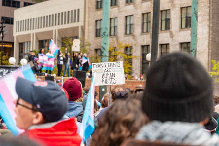 BOSTON, MASSACHUSETTS - OCTOBER 28, 2018: Protester marching for a peace pride rainbow flag at the...