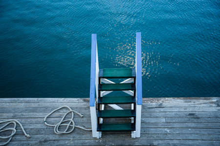 Wooden stairs and white railings on the deck of a ferry-shipの写真素材