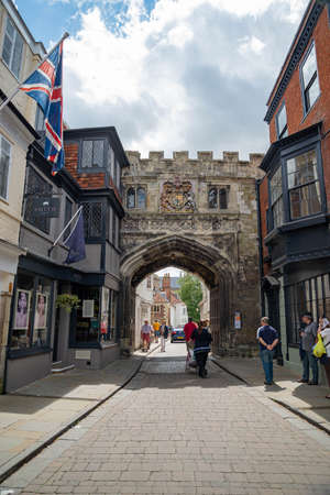 SALISBURY, UK - JULY 19, 2015: The medieval North Gate, known as the High Street Gate, to the Cathedral Close. Tourists walk along High Street, leading to Salisbury Cathedral.のeditorial素材