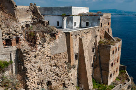 The old abandoned prison in the historic Palazzo d'Avalos on the Terra Murata cliffs, with panoramic view to the Bay of Naples and Mount Vesuvius - Procida Island, Italyの写真素材