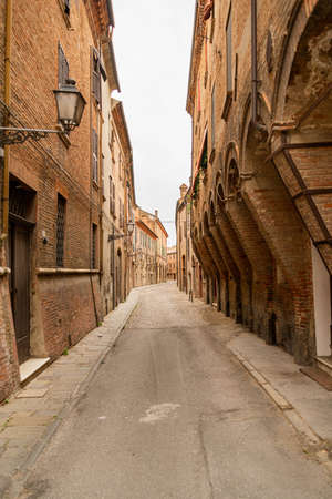 Cozy narrow street in Ferrara, Emilia-Romagna, Italy. Ferrara is an historical medieval city