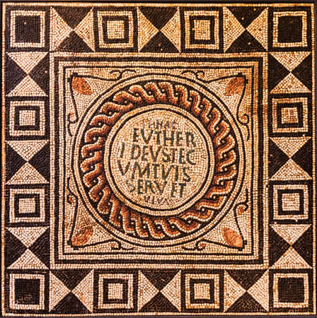 Fragment of an ancient floor mosaic. Colorful small tiles, ornament and regular forms. Roman, Italyの写真素材
