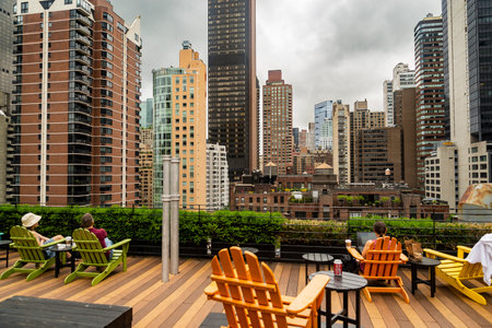 New York City midtown Manhattan skyline view with skyscrapers and cloudy sky in the day, USA