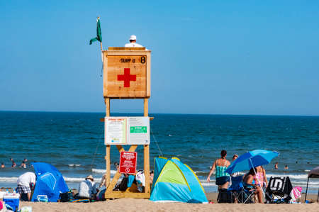 OLD ORCHARD BEACH ME - 13 AUGUST, 2012: Crowded colorful beach with people, beach umbrellas and sunbeds, summer vacations and tourism conceptのeditorial素材