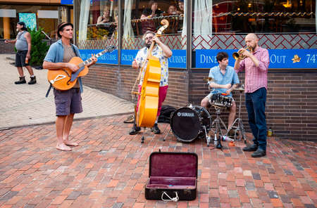 PORTLAND ME - AUGUST 6, 2021: Music street performers music on the sidewalk on summer outdoor day in...