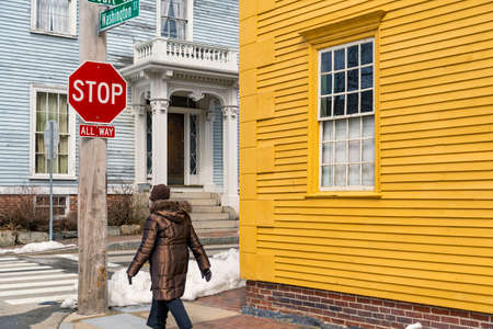 Street corner ad a person walking in the old historical center in Portsmouth NH, Americaの写真素材