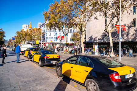 BARCELONA, SPAIN - DECEMBER 19, 2018: people take taxi cars on the street of Barcelona downtown.のeditorial素材