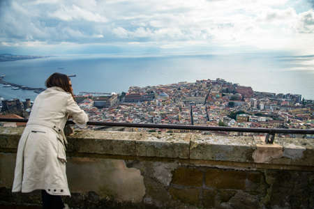 woman lay over a balcony from the castle overlooking the Napoliの写真素材