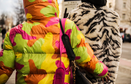 Young couple with colored clothes walking on the street of Berlin Germany.のeditorial素材