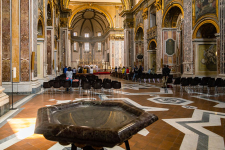 Priest starts the mass at the Basilica San Paolo Maggiore church in Naples, Italyのeditorial素材