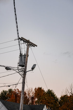 An electric pole against a gray sky in Maine, United Statesの写真素材