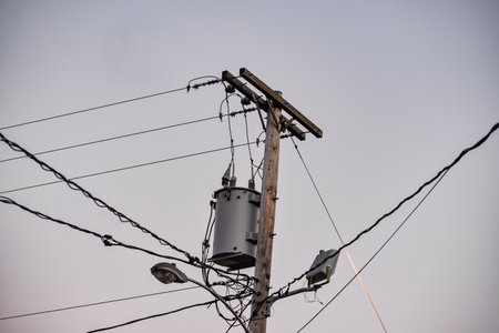 An electric pole against a gray sky in Maine, United Statesの写真素材