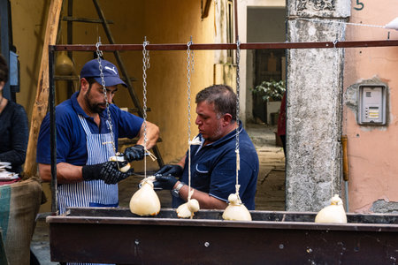 Vendors prepare caciocavallo cheese, called Impiccato, at the festival, autumn in Ospedaletto dAlpinolo near Avellino, Italyのeditorial素材
