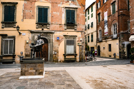 LUCCA, ITALY, APRIL 16, 2017: Detail of a bronze statue of Giacomo Puccini, famous Italian opera composer, in downtown of Lucca his hometown. Tuscany, Italy, Europe.の写真素材