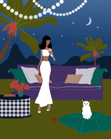 The Girl is Playing with the White Cat in the Garden at Nightの写真素材