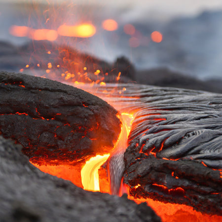 Lava flow from the volcano to the ground in the night.の素材