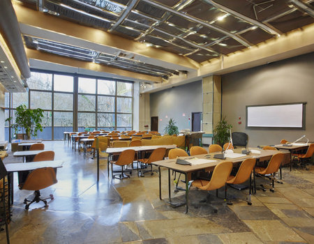 Interior of a conference room with tables, chairs and whiteboardの素材