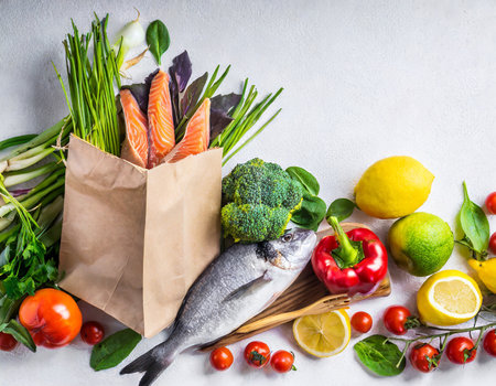 Healthy food background with fresh vegetables and fish in paper bag.の素材