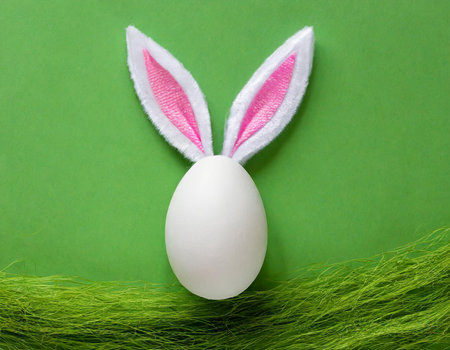Easter bunny ears and egg on green background. Happy Easter concept.の素材