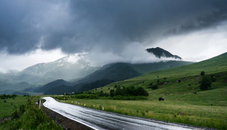 Road in the mountains under a cloudy sky. Caucasus, Russia.の素材