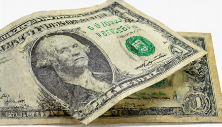 Close up of one dollar banknote on white background. Shallow depth of field.の素材