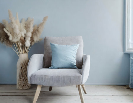 Comfortable armchair with pillows and vase on blue wall backgroundの素材