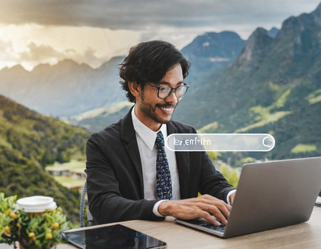 Searching Internet Data Information Networking Concept. Young Indian Businessman Working on Laptop Computer with Search Bar.の素材