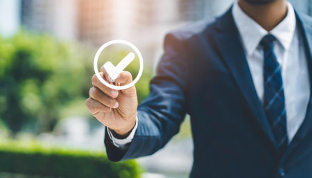 Businessman pressing check mark button on virtual screen,selective focus.の素材
