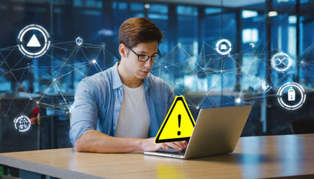 Digital composite of Businessman using laptop with alert sign and network interfaceの素材