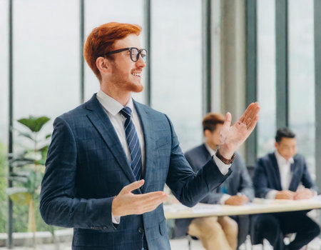 business, people and teamwork concept - smiling businessman with red hair in officeの素材