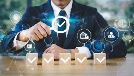 Businessman hand check mark icon on wooden block with checklist icon, Business and technology concept.の素材