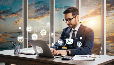 Businessman working with laptop in modern office with double exposure of business icons.の素材