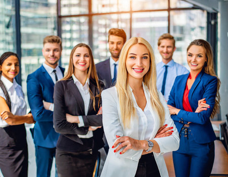 Portrait of smiling business team standing in office with arms crossed.の素材