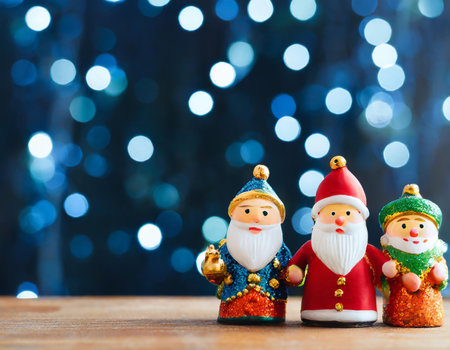 Christmas greeting card with Santa Claus and snowman on bokeh backgroundの素材