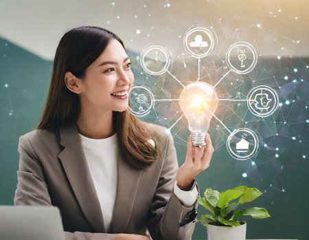 Young businesswoman holding light bulb in modern office with social network icons.の素材