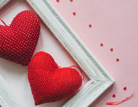 Valentine's day background with red hearts on a pink backgroundの素材