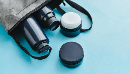 Binoculars and black case on blue background. Top view.の素材