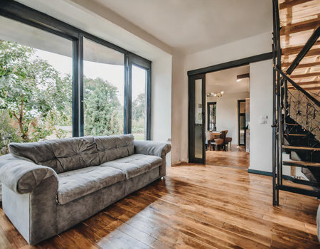 Luxury living room with grey sofa and wooden floor. Nobody insideの素材