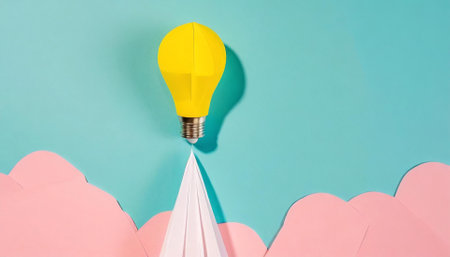 Creative idea concept with paper plane and light bulb on blue backgroundの素材