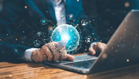 Businessman using laptop with global network connection hologram. Technology concept. Double exposureの素材