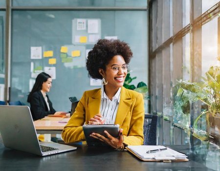 Portrait of smiling african american businesswoman using tablet in office.の素材