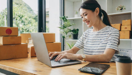 Young asian woman working at home office, online shopping concept.の素材