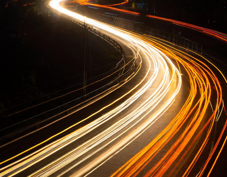 Light trails on the road at night. Long exposure photo taken in a tunnel.の素材