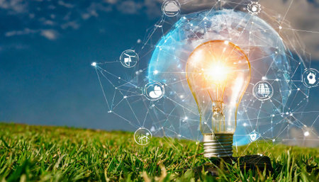 Glowing light bulb on green grass with social media icons flying aroundの素材