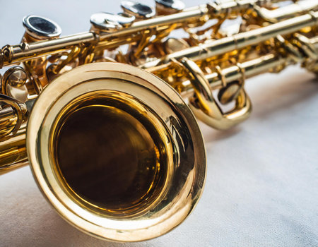 Close up of a saxophone on a white background, selective focusの素材